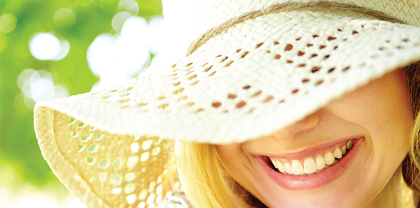 woman smiling waering hat sun protection