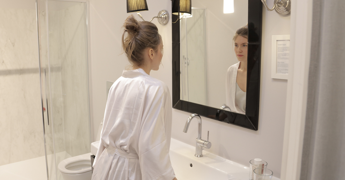 woman looking on mirror