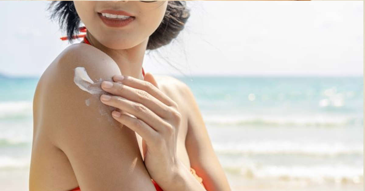 girl applying sunscreen beach