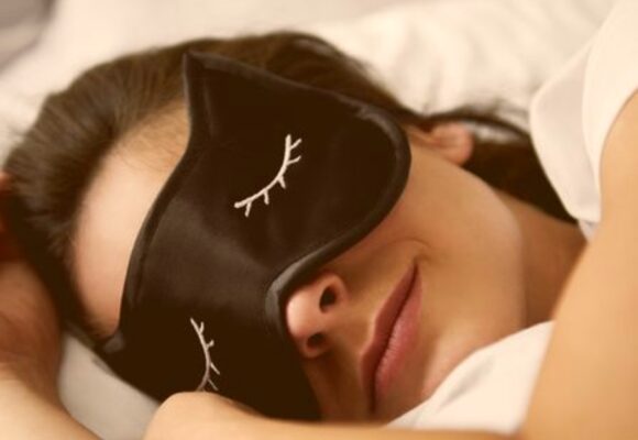 portrait-of-young-woman-with-sleep-mask-in-bed-royalty-free-image-1074270536-1565885674