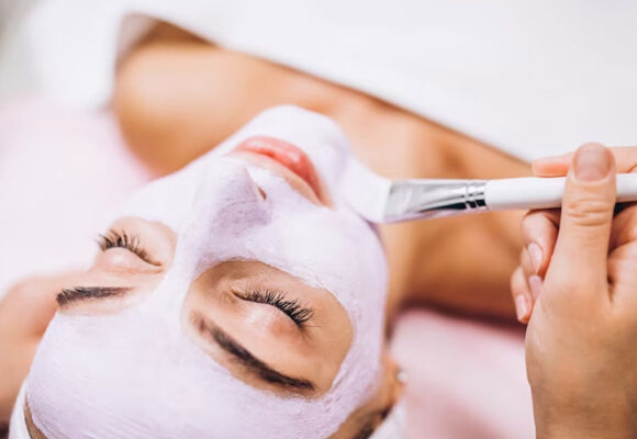 cosmetologist-applying-mask-face-client-beauty-salon