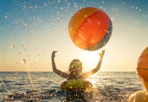 happy-child-having-fun-on-summer-vacation-kid-playing-with-rubber-duck-and-ball-in-the-sea