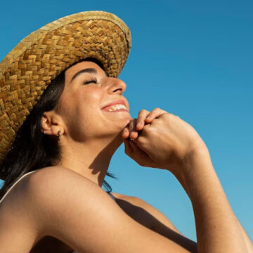smiley-woman-posing-beach-side-view