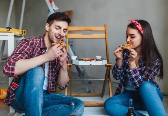 happy-couple-doing-repairs-home-have-romantic-time-eating-pizza